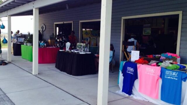Vendor tables set up under a covered pavilion at the Bay Creek Park market on Edisto